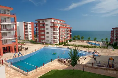 a large swimming pool next to some apartment buildings at Marina and Panorama Deluxe Apartments in Burgas City