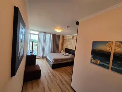 a small room with a bed and a window at Sea View Luxury Penthouse in Sunny Beach