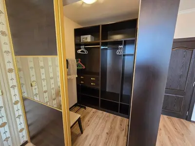 a walk in closet with a large black refrigerator at Sea View Luxury Penthouse in Sunny Beach