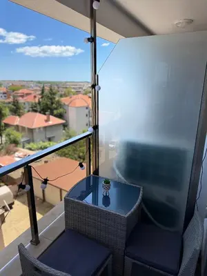a table and chairs on a balcony with a view at Sea Sun in Burgas City