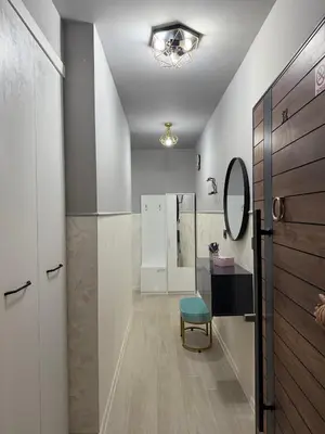 a bathroom with a table and a blue chair at Sea Sun in Burgas City