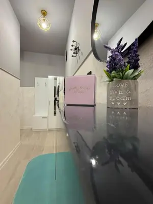 a room with a glass table with flowers on it at Sea Sun in Burgas City