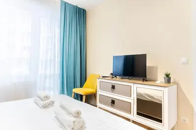 a room with two beds and a television on a dresser at Arena MALL Galleria Securities Parking 3 in Burgas City