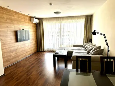 a living room with a couch and a table at Platinum apartment in Bŭnzareto