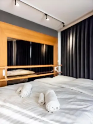 a bed with three rolled towels on top of it at Arena MALL Galleria & Parking 4 in Burgas City