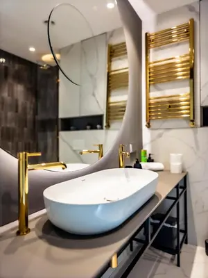 a bathroom with a white sink and a mirror at Arena MALL Galleria & Parking 4 in Burgas City