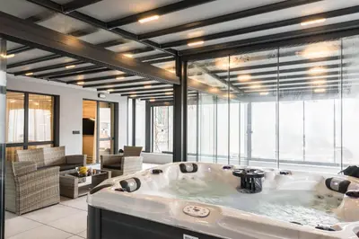 a large bath tub in a room with large windows at City Center Luxury Apartments in Varna City