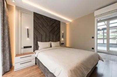 a bedroom with a large bed and a large window at City Center Luxury Apartments in Varna City