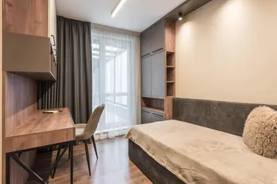 a bedroom with a bed and a desk and a table at City Center Luxury Apartments in Varna City