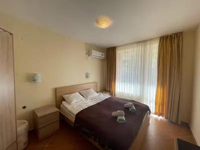 a bedroom with a bed with two shoes on it at Panorama Dreams - Prestige Apartments in Sveti Vlas