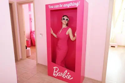 a woman is standing in a pink bathroom mirror at Barbie-Themed 3BDR Penthouse Near The Beach, Nessebar in Nesebar