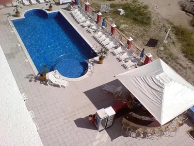 an overhead view of a swimming pool with chairs and an umbrella at Carina Beach - Private apartment - BSR - 3 in Sunny Beach