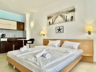 a bedroom with a large white bed and a desk at Carina Beach - Private apartment - BSR - 3 in Sunny Beach