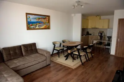 a living room with a couch and a table and chairs at Морски бриз in Shkorpilovtsi