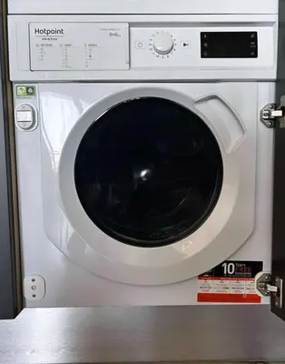 a white washing machine with its door open at The better apartment in Burgas City