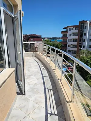a balcony with a view of a building at Sineva Apartments in Ravda