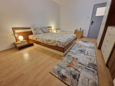 a bedroom with a bed and a rug at Sea apartment- Gurko in Burgas City