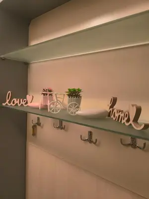 a shelf with two plants and a bike on it at Sea apartment- Gurko in Burgas City
