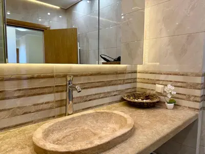 a bathroom with a sink and a mirror at Cosher Gardenia Palace Apt 6 Free Parking in Pomorie