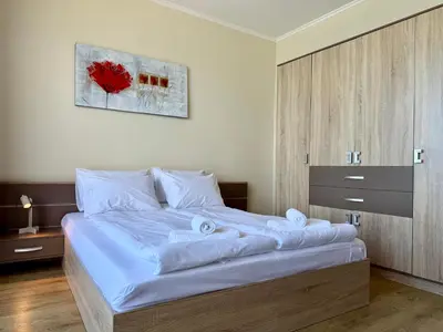 a bedroom with a large bed with towels on it at Cosher - Gardenia Palace Apt 10 Free Parking in Pomorie