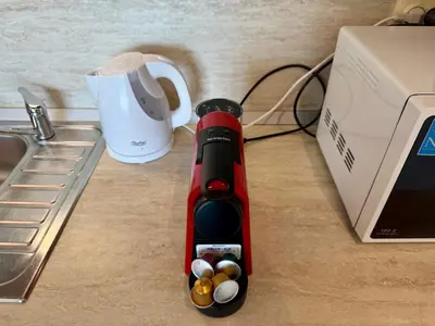 a red blender sitting on a counter next to a laptop at Cosher - Gardenia Palace Apt 10 Free Parking in Pomorie