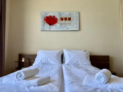 a bedroom with two beds with towels on them at Cosher - Gardenia Palace Apt 10 Free Parking in Pomorie