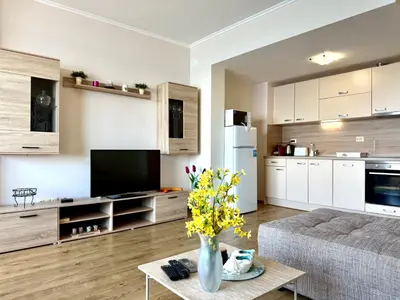 a living room with a couch and a table with flowers at Cosher - Gardenia Palace Apt 9 Free Parking in Pomorie