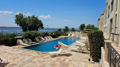 a swimming pool with lounge chairs next to a building at Cosher - Gardenia Palace Apt 9 Free Parking in Pomorie