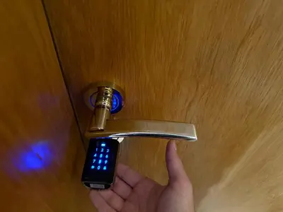 a person holding a door handle with a remote control at Cosher - Gardenia Palace Apt 9 Free Parking in Pomorie