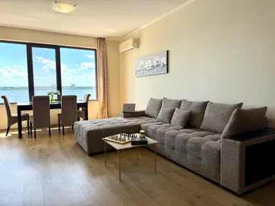 a living room with a couch and a table at Cosher - Gardenia Palace Apt 11 Free Parking in Pomorie