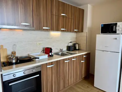 a kitchen with a sink and a white refrigerator at Cosher - Gardenia Palace Apt 11 Free Parking in Pomorie