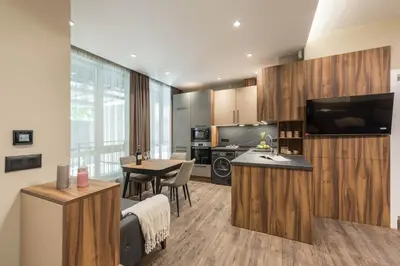 a room with a kitchen and a living room at City Center Luxury Studio in Varna City