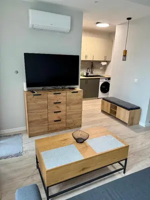 a living room with a flat screen tv and a coffee table at Work and Relax Studio in Green Life Beach Resort in Sozopol