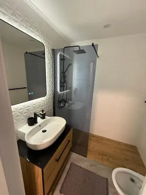 a bathroom with a sink and a toilet and a mirror at Work and Relax Studio in Green Life Beach Resort in Sozopol