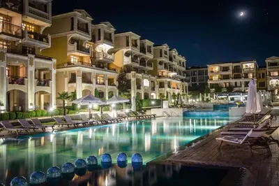 a swimming pool in front of a hotel at night at Work and Relax Studio in Green Life Beach Resort in Sozopol