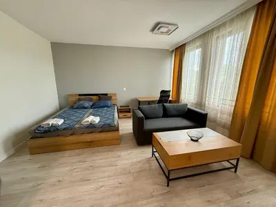 a living room with a bed and a couch at Work and Relax Studio in Green Life Beach Resort in Sozopol