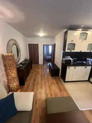 a large living room with a couch and a kitchen at Нощувки Град Бяла Terrazza sul mare in Byala
