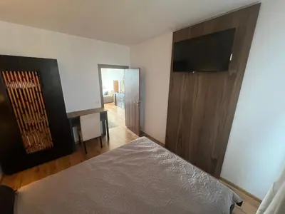 a bedroom with a bed and a flat screen tv at Нощувки Град Бяла Terrazza sul mare in Byala