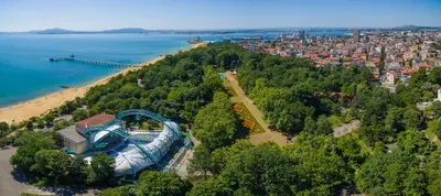 an aerial view of a building on a hill next to a beach at Deluxe studio beach Lazur in Burgas City