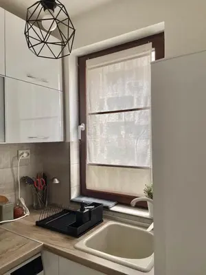 a kitchen with a sink and a window at Deluxe studio beach Lazur in Burgas City