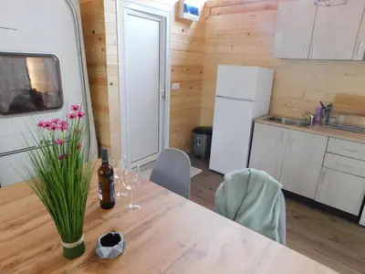 a kitchen with a table with a bottle of wine at The magical place in Chernomorets