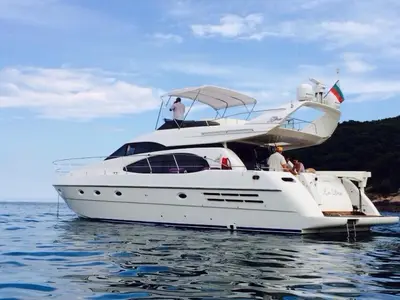 a white boat in the water with people on it at Azimut in Nesebar