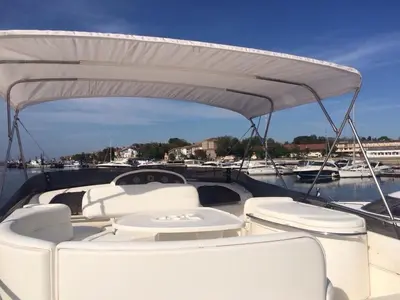 a white boat with white seats on a marina at Azimut in Nesebar