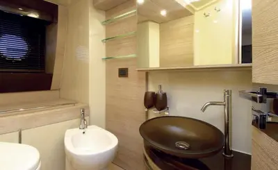a bathroom with a black sink and a toilet at Azimut in Nesebar