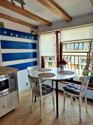a kitchen with a table and chairs and a microwave at Blue Vista Apart in Burgas City