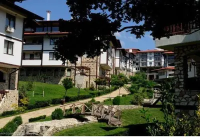 a bridge over a path in a city with buildings at Етъра - 2 Rey&Mar Свети Влас in Sveti Vlas