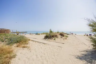 a sandy beach with people on the beach at Marea in Pomorie