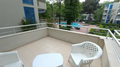 a balcony with two chairs and a table and chairs at Excelsior Prince ApartHotel in Sunny Beach
