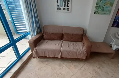 a brown couch in a living room with a table at Excelsior Prince ApartHotel in Sunny Beach