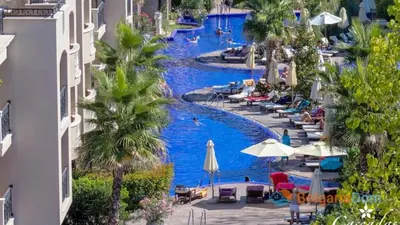 a view of a pool with people in a resort at Апартамент Каскадас in Sunny Beach